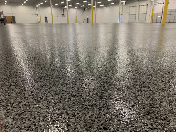 IMG_4426 Industrial warehouse space with a cleanly polished, speckled concrete floor.